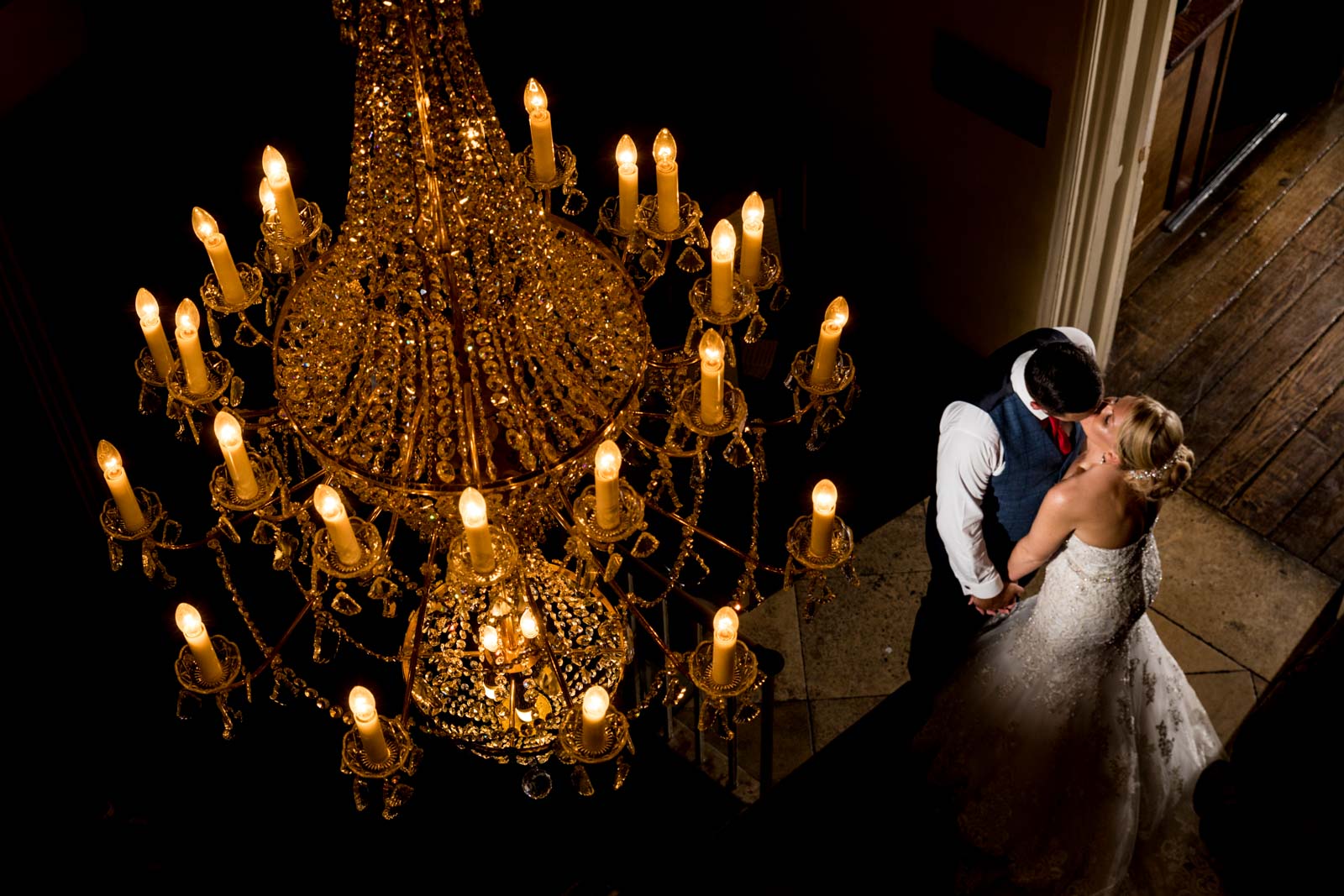 Beautiful chandelier photo taken of the couple kissing at offley place