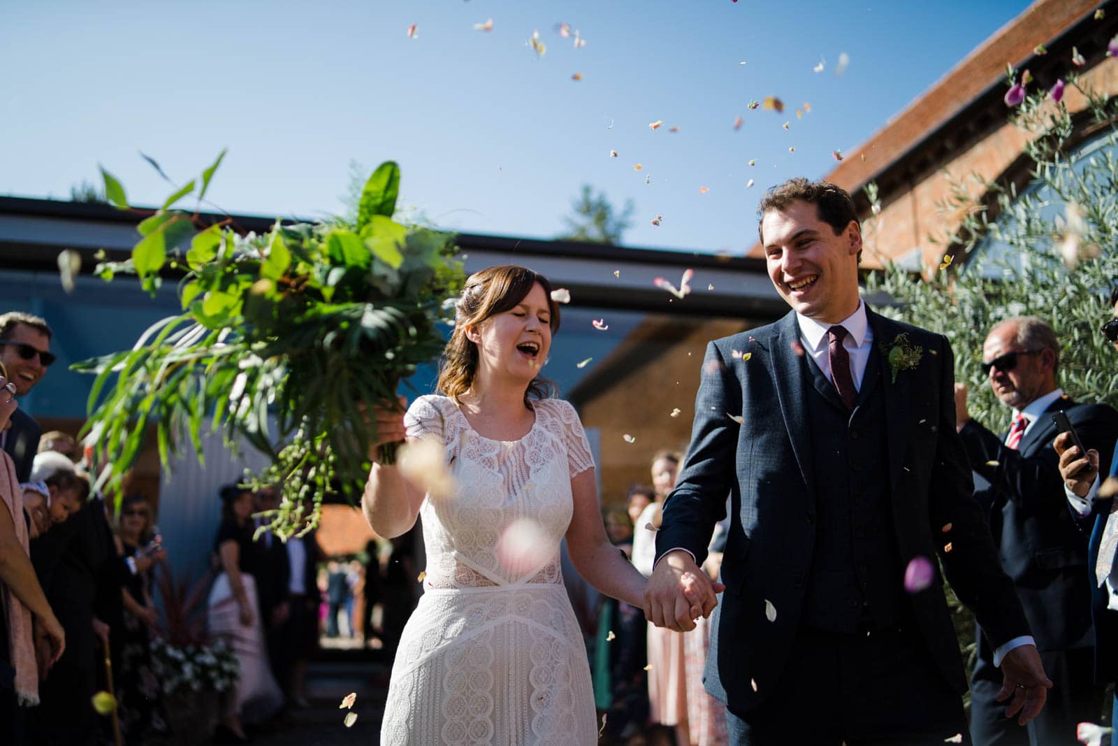 Bride and groom receiving confetti Wedding Photographer Warwickshire