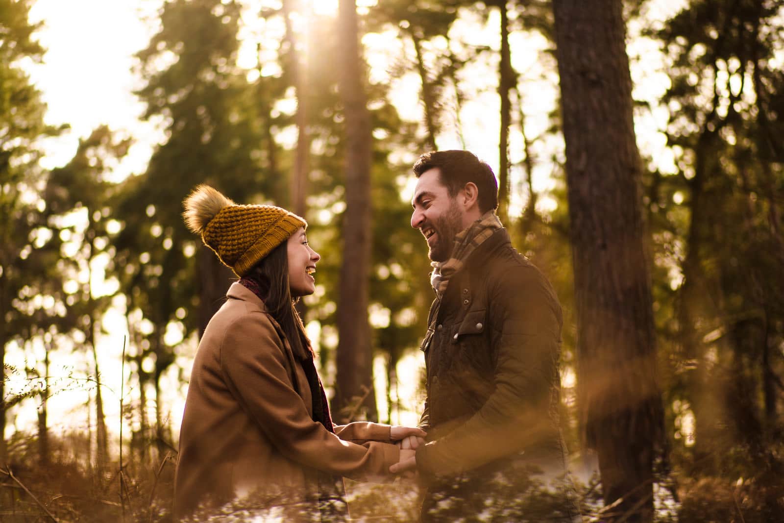Couple laughing in beautiful backlit golden sun